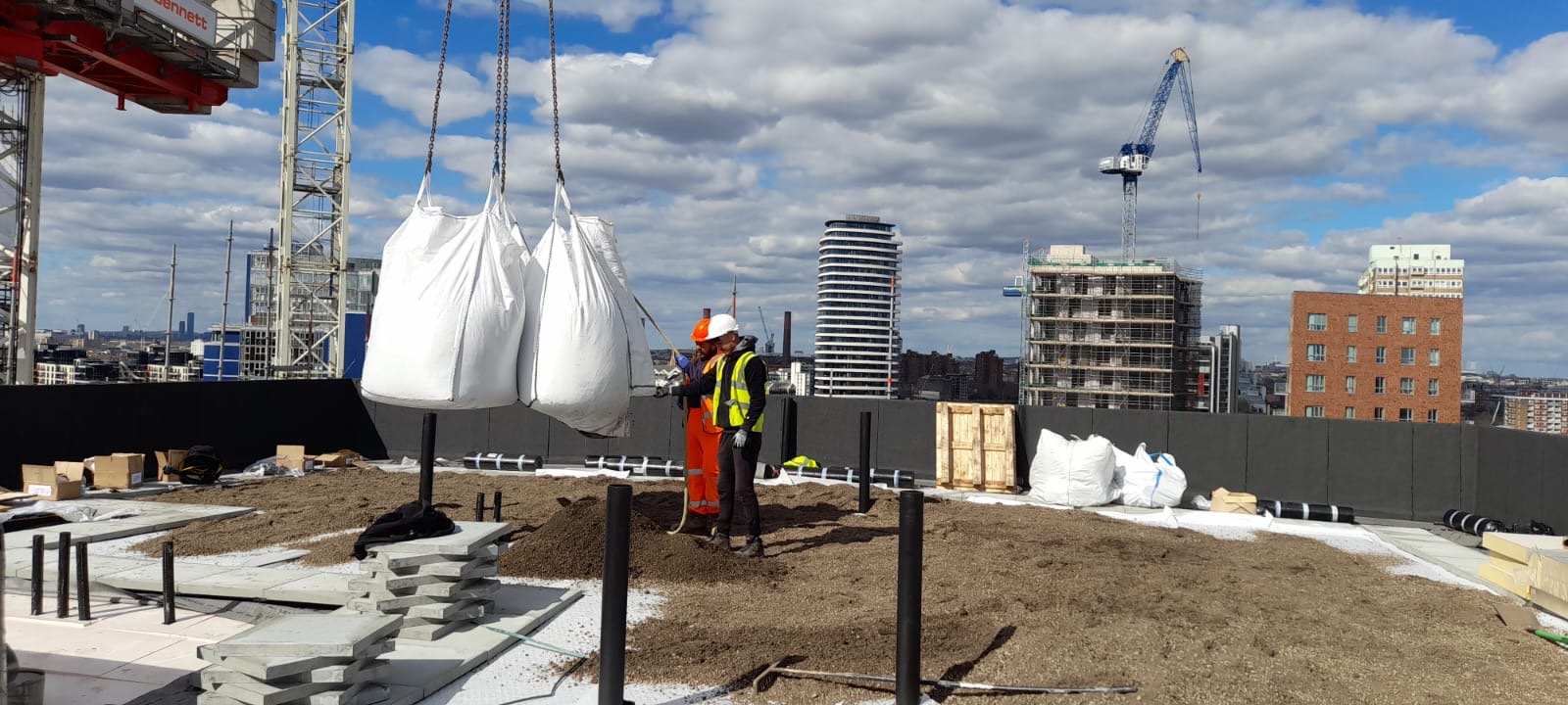 Roof installation materials being delivered by crane